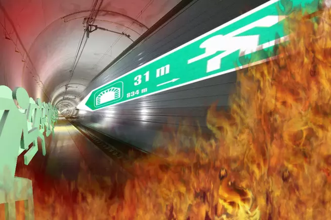 U-Bahn-Schiene mit Feuer und grafischen Symbolen im Tunnel.